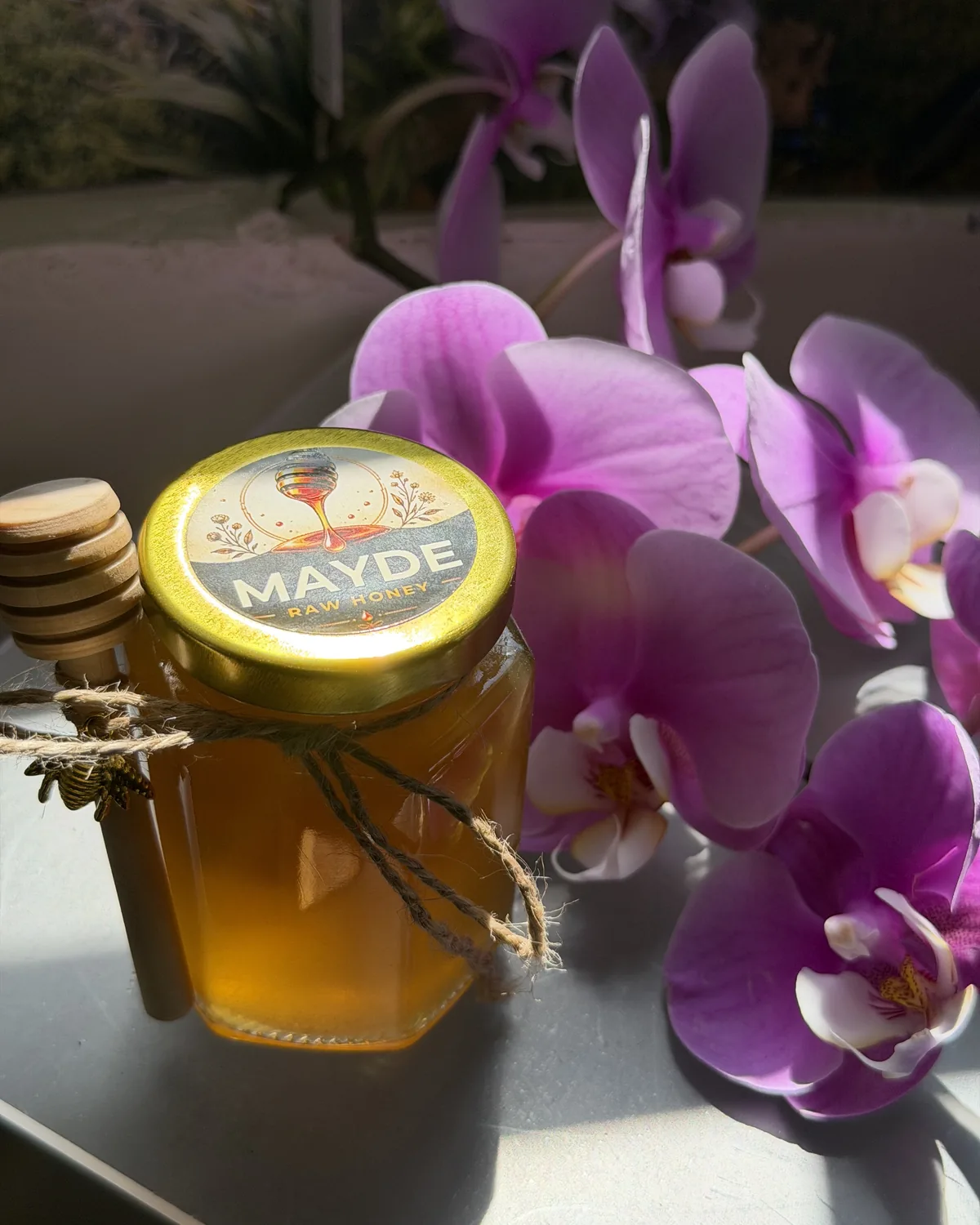 MAYDE raw honey jar with a wooden dipper at MAYDE Market in Cameron Park